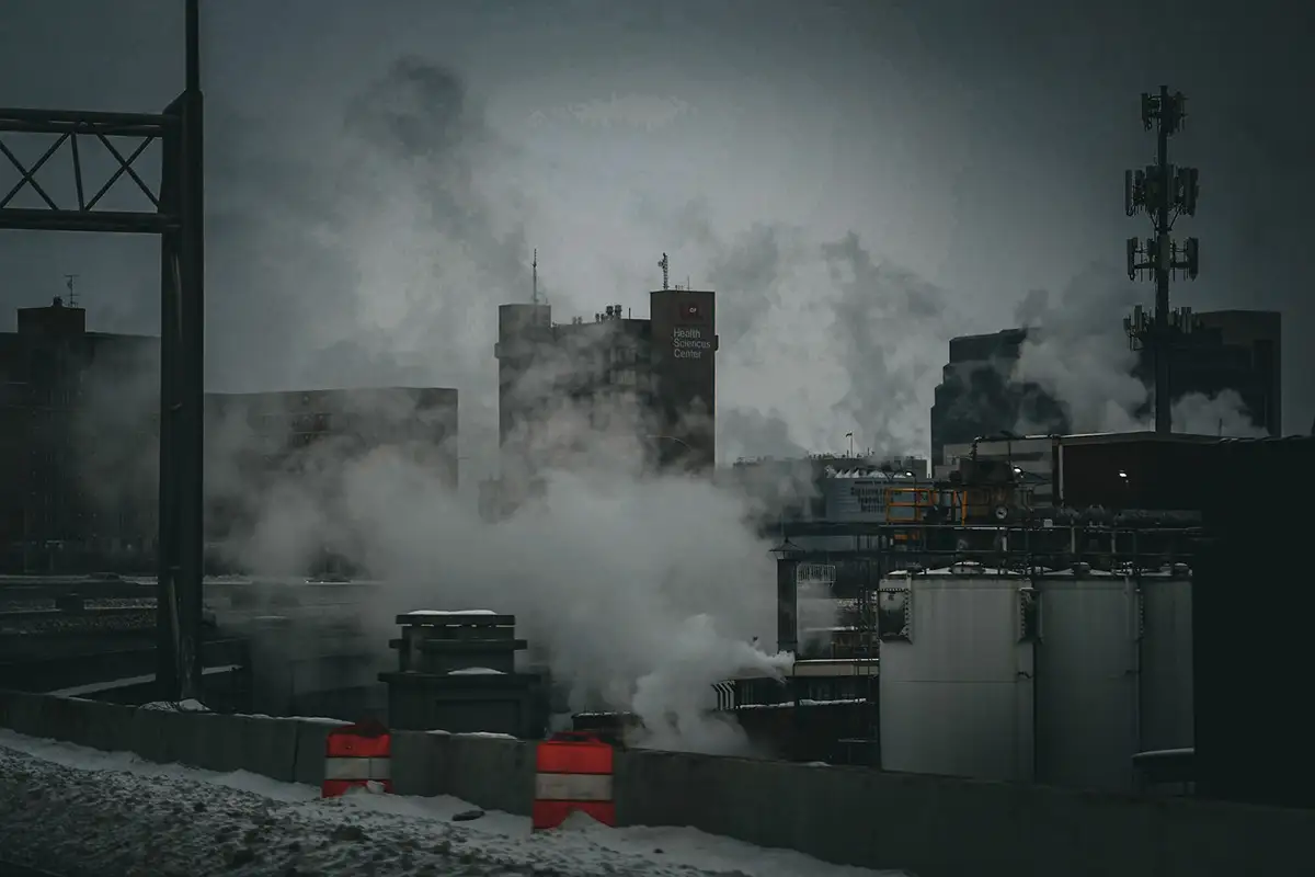 Steam rising over a gray industrial skyline
