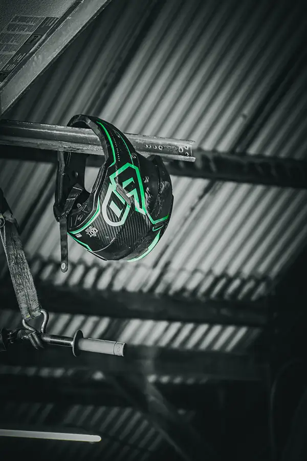 Black-and-white edit of a football helmet hanging on a rack