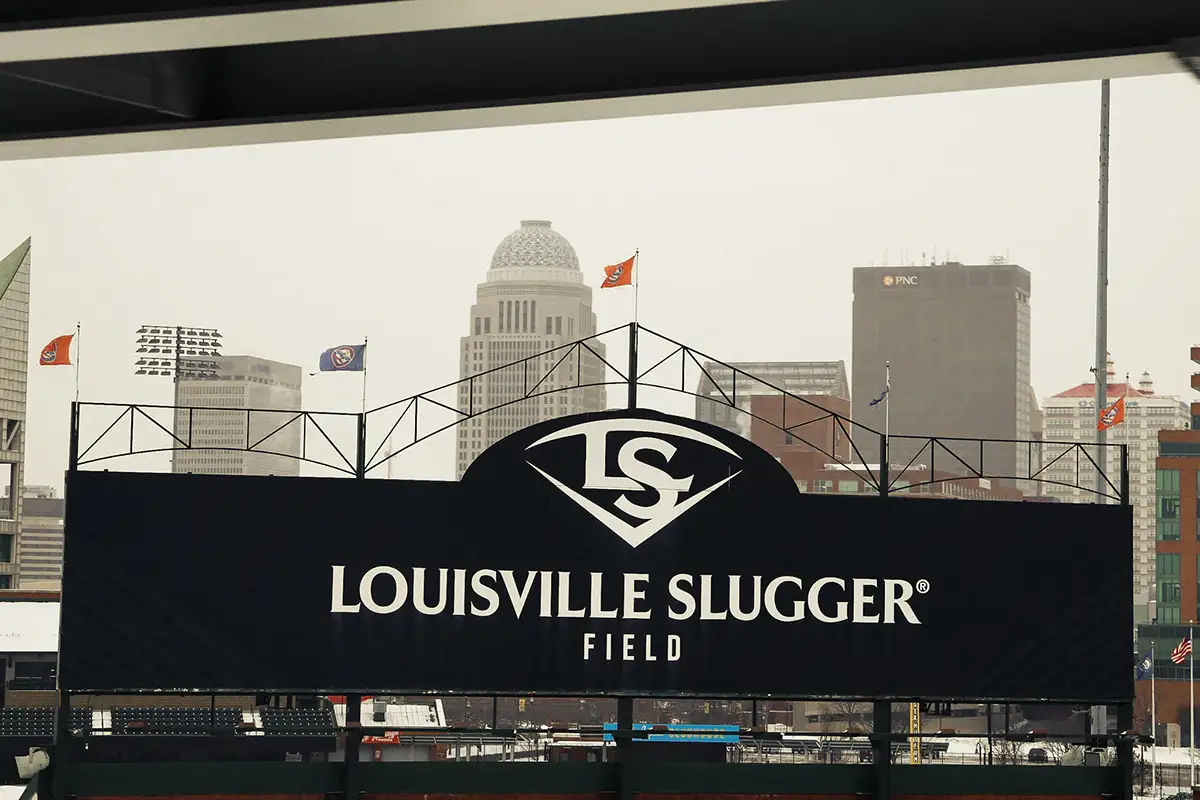 Louisville Slugger Field sign with the city skyline behind