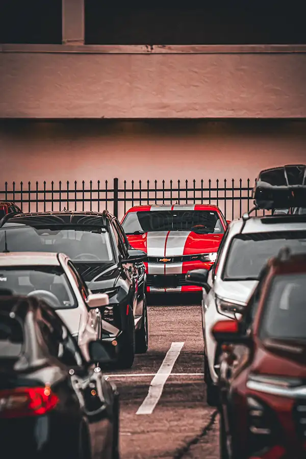 Row of parked cars, a red sports car among them