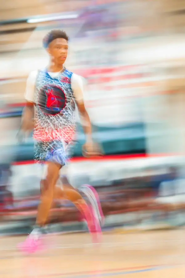 Basketball player dribbling, edited with heavy motion blur