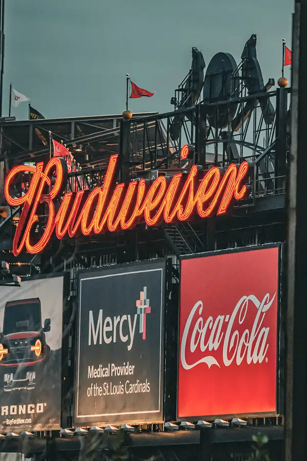 Budweiser and Coca-Cola signs at a ballpark