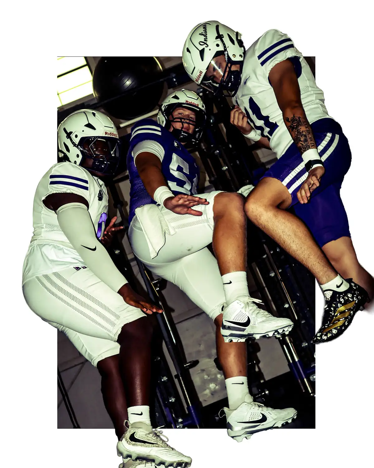 Football players piled together, cut out on white
